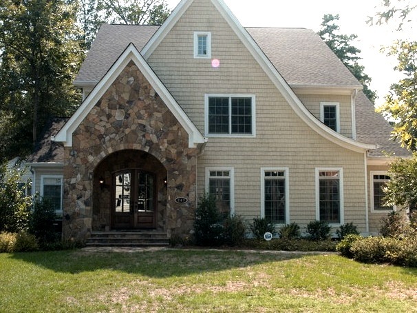 Idea for a large, brown, two-story stone exterior house